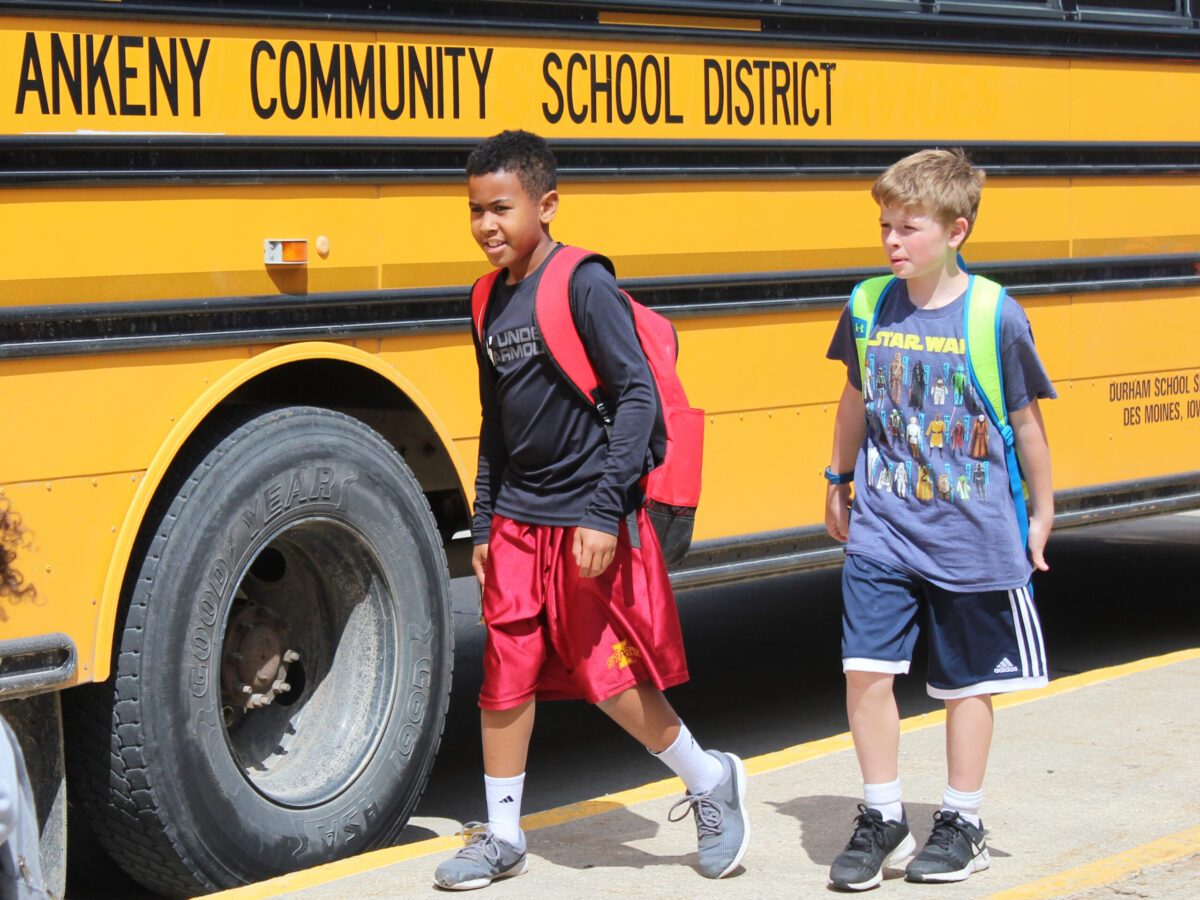 students walking by school bus