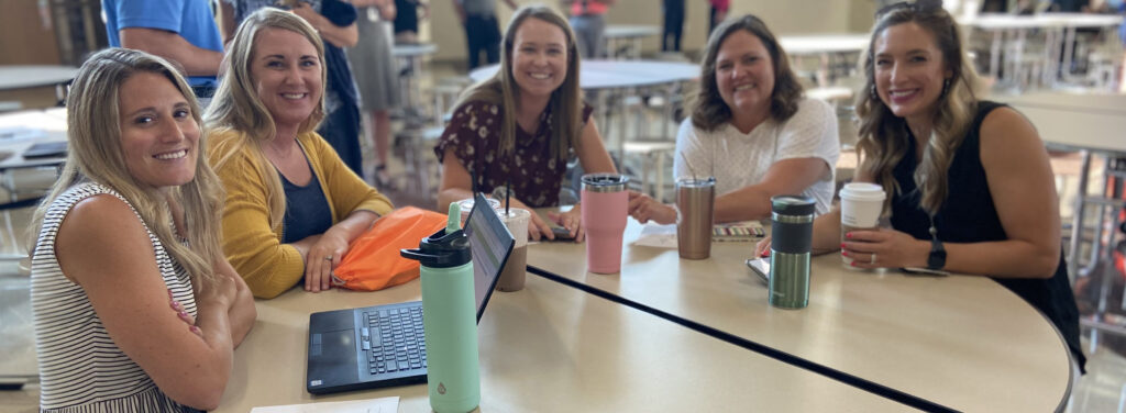 New teachers sitting at table